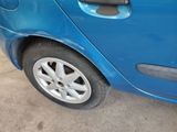 a blue car that is parked on the side of the road