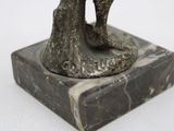 a statue of a man and a woman kissing on a marble base