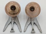two metal objects that are on a white surface