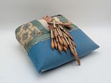 a blue pillow with a bunch of wooden sticks on it