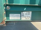 a close up of a green truck with a license plate