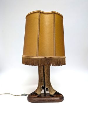 une photo d'une lampe de table sur laquelle repose une patte de cerf