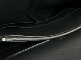 a close up of a black purse with a zipper
