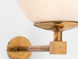 a close up of a wall light with a glass ball on it