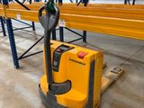 the forklift is parked in the warehouse with the pallet in the foreground