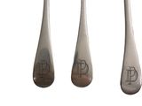 three silverware spoons and a fork with a monogram on them