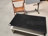 a black table and a white chair in a room