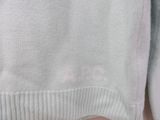 a close up of a person wearing a sweater with a cat on it