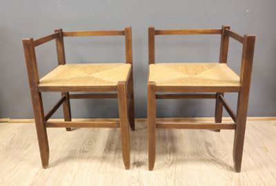 two wooden chairs sitting on top of a hard wood floor