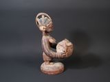 figurine of a woman holding a baby in her arms