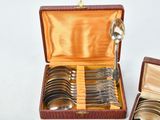 several spoons and spoon spoons are in a case on a white surface
