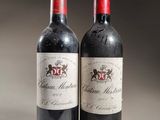 two bottles of red wine sitting next to each other on a table