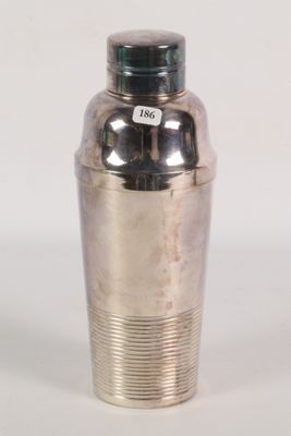 silver plated cocktail shaker with a black lid on a white background