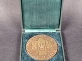 an image of a gold medal in a green case