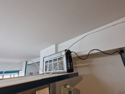 a white microwave sitting on top of a shelf next to a window