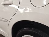 a close up of a white car with a black stripe on the door