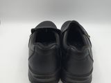 a pair of black shoes on a white surface