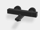 un gros plan d'un objet noir sur une surface blanche