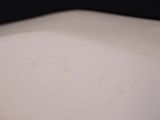 a close up of a white sink with a black background