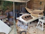 several pieces of wood are stacked on a table in a yard