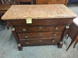 an image of a wooden dresser with a marble top and drawers