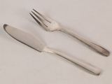 two forks and a knife on a white table