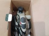 a box with a corded sander inside of it