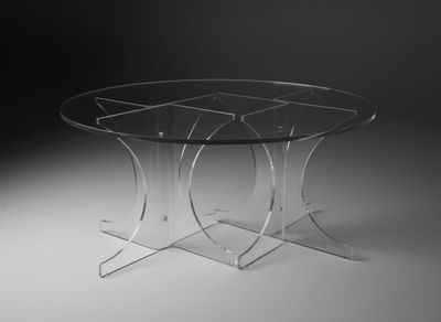 a glass table with three legs and a glass top