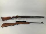 a pair of shotguns, one with a rifle and the other with a gun