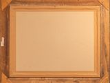 an old wooden picture frame with a picture hanging on the wall