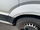 a close up of a white truck with a flat tire