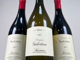 three bottles of wine sitting next to each other on a table