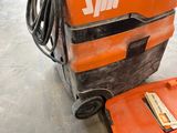 an orange and black machine that is sitting on the floor