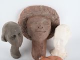 three clay sculptures of a woman and two elephants