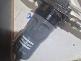 a close up of a drill on a table with other tools