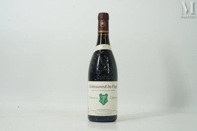 the bottle of wine is sitting on a white surface