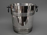 a large silver ice bucket with handles on a table