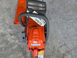 an image of a chainsaw that is on the ground