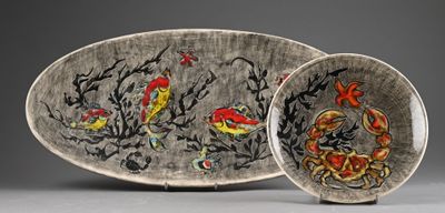 two plates with designs on them sitting on a table