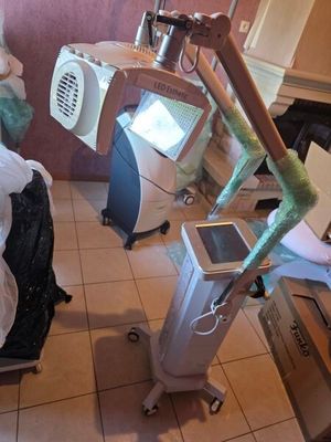 a room with a bed and a computer on a stand
