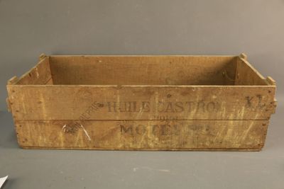 an old wooden box with a sign on it sitting on top of a table