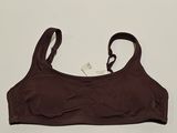 a close up of a brown bra top on a white surface
