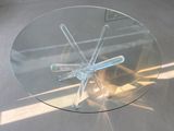 a glass table with a glass top and a metal base