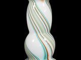 a glass vase that has a spiral design on it