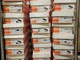 many boxes of shoes stacked on top of each other