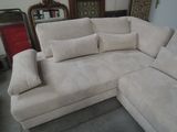 a large sectional couch with pillows on it in a room