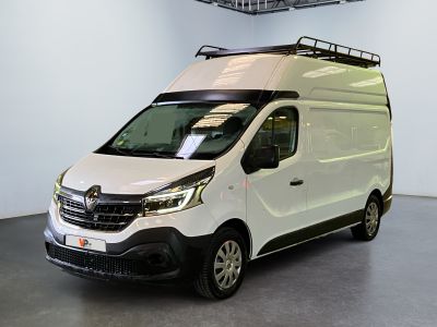 the white van is parked inside of a building with a roof rack