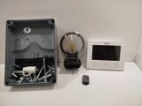 a box with screws, screws, and a remote control on a table