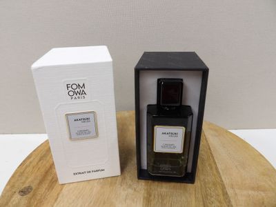 a bottle of perfume sitting on top of a wooden table