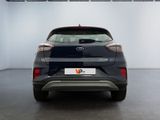 the rear end of a black car in a white room